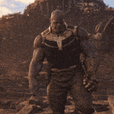 thanos from the movie avengers infinity war stands in front of a building