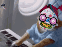 a cat wearing a clown mask and glasses is playing a keyboard