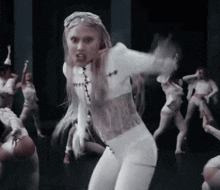 a woman in a white outfit has a tattoo on her chest that says ' i love you '