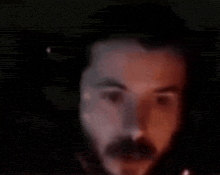 a blurry picture of a person 's face with their mouth open .