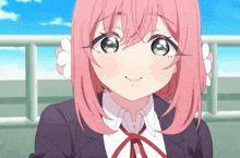 a girl with pink hair and green eyes smiles