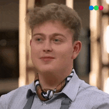a young man wearing a scarf around his neck