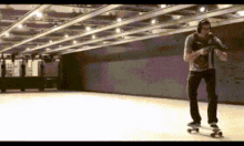 a man wearing headphones is riding a skateboard in a subway station .