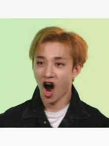 a young man with a surprised look on his face .