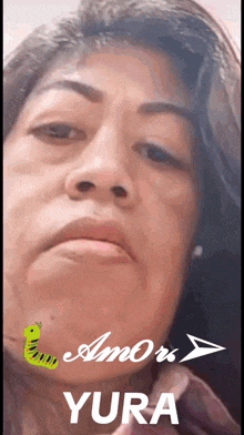 a close up of a woman 's face with the words amor yura on the bottom