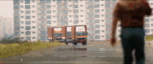 a man walking in front of a row of trucks one of which says mdh