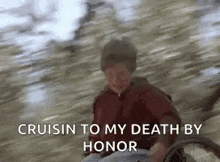 a man in a wheelchair is riding down a hill with the words `` cruisin to my death by honor '' .