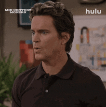 a man 's face is shown in a hulu ad for mid-century modern