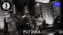 a black and white photo of a group of people playing instruments with the words put3ska on the bottom