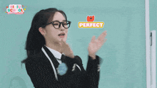 a girl wearing glasses and a suit with the word perfect on it