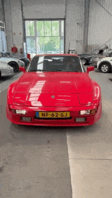 a red sports car with a license plate that says nf-62-sj
