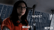 a woman wearing glasses is sitting in the back seat of a car and asking why and what .