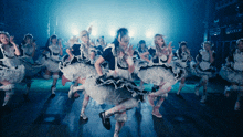 a group of maids are dancing on stage