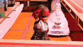 a cartoon character with red hair and blindfolds is holding a sword in front of a woman in a white dress .