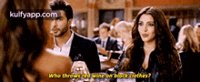 a man and a woman are talking in a restaurant .