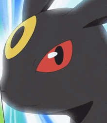 a close up of a black animal with red eyes and a yellow eye