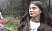 a woman with long hair is wearing a shirt that says " land "