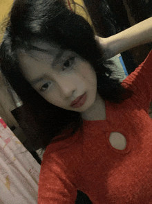 a woman in a red sweater takes a selfie