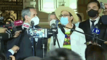 a group of people wearing face masks are standing in front of microphones with the word pd on them