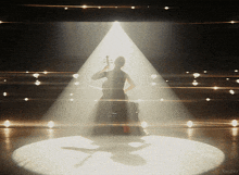 a woman playing a violin in front of a spotlight with the word kepler in the corner