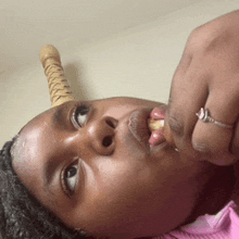 a woman with a ring on her finger is laying down