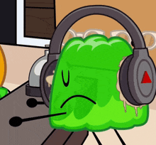 a green cartoon character wearing headphones with a red triangle on them