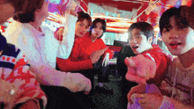 a group of young men are sitting in a car and making funny faces .