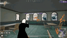 a man is holding a gun in a room with tables and chairs ..