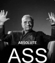 a black and white photo of a man with his hands in the air and the words absolute ass on the bottom