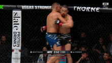 two fighters in a cage with a slate protein drinks ad in the background