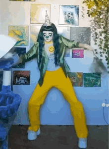 a woman in a green jacket and yellow pants dancing