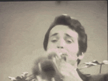 a man is playing a trumpet in a sepia tone photo