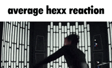 a person is standing in front of a wall with the words average hexx reaction written on it .