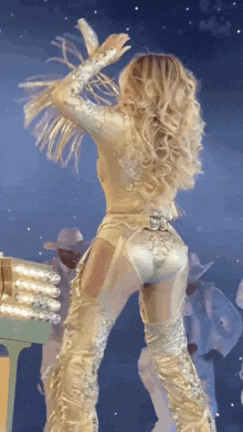 a woman in a very revealing outfit is dancing on a stage