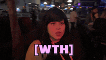 a woman is standing in front of a sign that says ' [ wth ] '