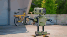 a green robot is riding a skateboard in front of a bike