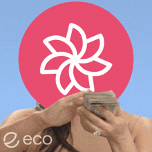 a woman is holding a stack of money in front of a red circle with a flower in it