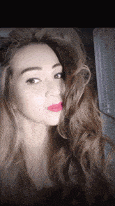 a close up of a woman 's face with long hair
