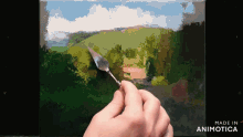 a person is painting a landscape on a canvas with the words made in animotica below them