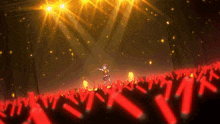 a woman is standing in front of a crowd with red lights
