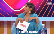 a woman in a blue dress is holding a sign that says " nobody cares "