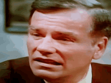 a close up of a man 's face with a serious expression