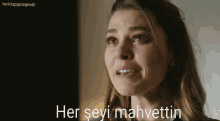 a woman is crying with her eyes closed and the words her seyi mahvettin behind her