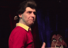 a man in a red shirt with the words to me that does n't seem