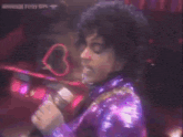 a man in a purple shirt is saying got a lion in my pocket ..