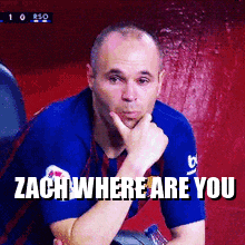 a man in a blue shirt is sitting with his hand on his chin and a caption that says zach where are you
