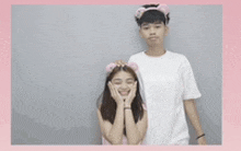 a boy and a girl are posing for a picture and the girl is wearing a pink headband
