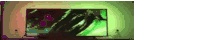 a tv with a green screen is turned on in a dark room