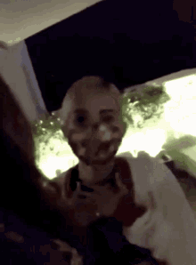 a woman with a mask on her face talks to another woman