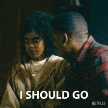 a man and a woman are looking at each other and the woman says i should go netflix